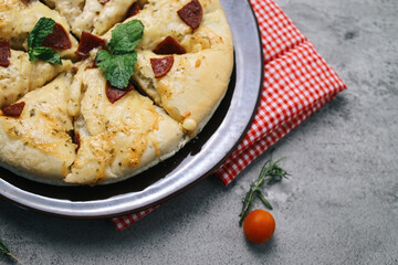 Margerita Cheese Pizza on Red Checkered Cloth Isolated on Gray Background 
