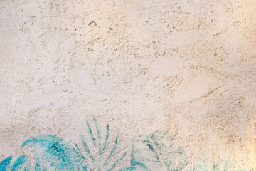 Old concrete light brown texture with blue green leaf printed paint on background