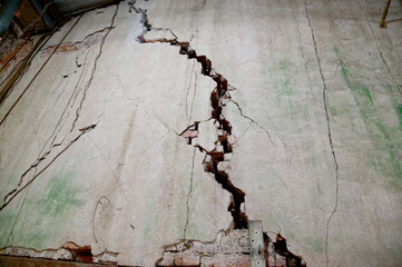The Old Cracked Wall of a concrete building. A part of the red brick wall was abandoned at Thailand.