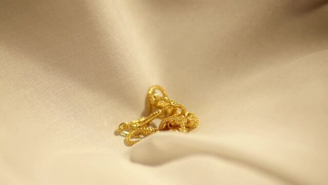 Gold Wedding Necklace dropped on velvet cloth. Jewelry for Weddings and engagements.