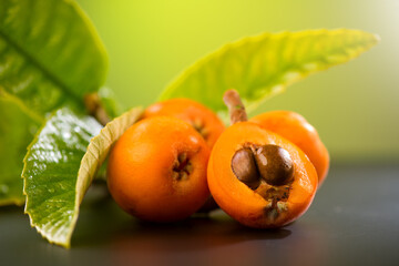 Medlar, Loquat fruit or Japanese medlars, Nispero, Eriobotrya japonica with leaves fresh ripe bio vegetarian food, medlar berries. Close up 