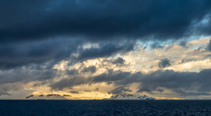 An Antarctic landscape, taken during the golden hour, just after sunrise, in the Gerlache Strait.