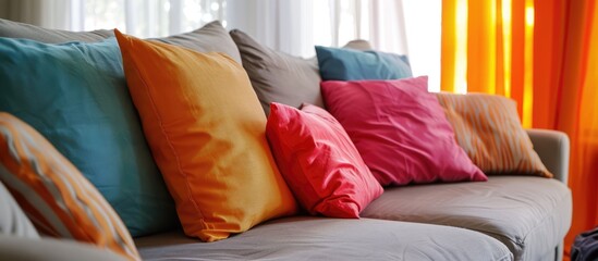 Decorative pillow in vibrant hues placed on the couch in the living room.