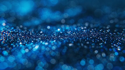 Vivid blue light bokeh on a dark background creating a sparkling and enchanting abstract pattern.