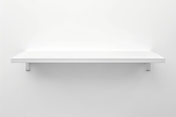 A white shelf mounted on a white wall, creating a minimalistic and clean look