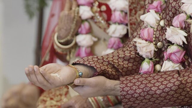 Close-up View Of A Groom's Hand Holding Rice During The Rituals In The Indian Wedding Ceremony.