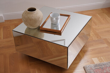 Modern mirror table with a cup on a glass tray
