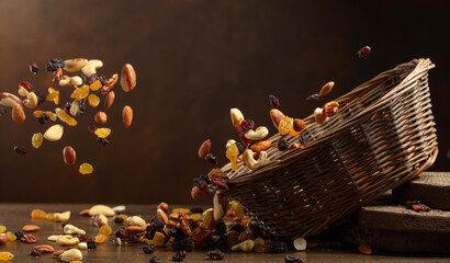 Dried fruits and nuts fall in basket.