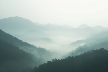 Layers of misty mountains fading into the distance, creating a mystical and serene atmosphere in the early morning light.