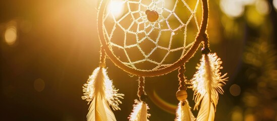 Handmade dreamcatcher adorned with feathers, threads, beads, and a hanging rope.