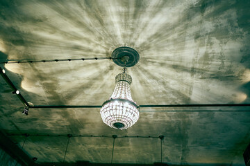 A chandelier with lamps. Light in the interior. The chandelier is made of antique glass. Ceiling...