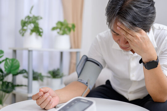 Asian senior man disappointed and sad With the test results for diabetes and high blood pressure, use a blood pressure monitor to check yourself and prevent diabetes and high blood pressure at home.