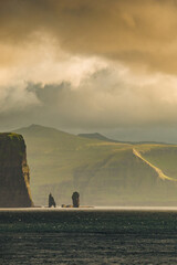 Faroe Islands, Eysturoy island. Cover page with gorgeous sunset over Risin og Kellingin rock...