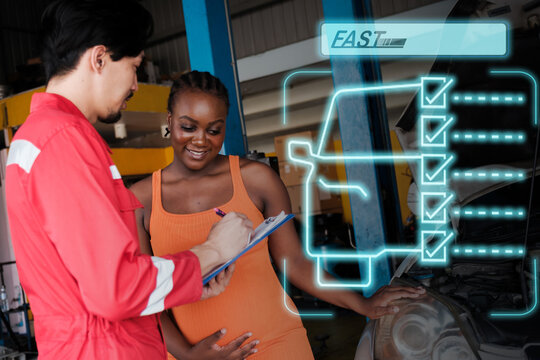 Car mechanic inspects car using technology and computer show resault at virtual screen.
