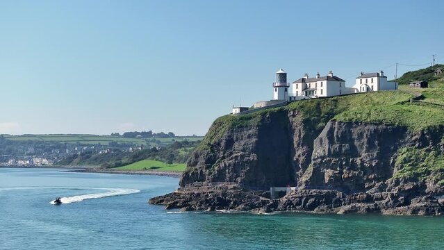 Blackhead Lighthouse near seaside town Whitehead in County Antrim, Northern Ireland. Aerial 50fps UHD