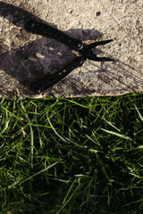 multitool on the background of the garden