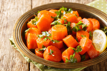 Vegetarian carrot salad with cilantro, spices, lemon juice and olive oil close-up in a plate on a...