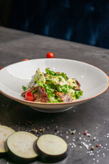 Warm salad with beef tender sauce and cherry tomatoes