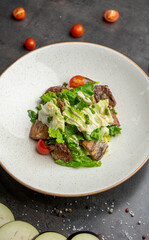 Warm salad with beef tender sauce and cherry tomatoes
