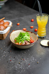 Salad with beef, cherry tomatoes and orange juice