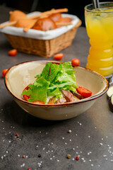 Salad with beef, cherry tomatoes and orange juice