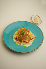 fish in cream sauce with vegetables on background