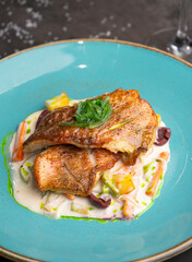 fish in cream sauce with vegetables and white wine