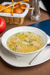 chicken soup with a basket of bread in a restaurant