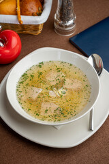 chicken soup with a basket of bread in a restaurant