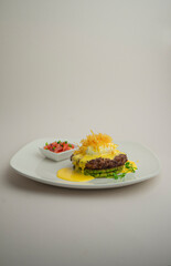 Beef steak with tender mousse on a gray background