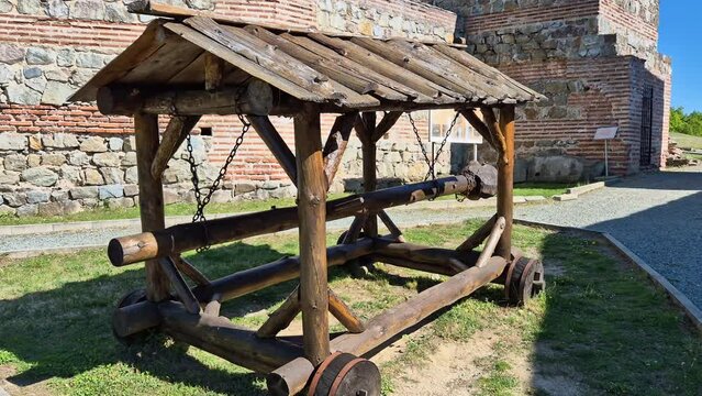 Medieval wooden battering ram. Reconstructed ancient weapon. Back view.