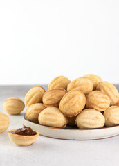Russian cookies Nuts or Oreshki in shape of a walnut with boiled condensed milk. Russian cuisine, desserts. Copy space.
