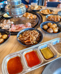 Authentic Korean BBQ experience with meats, side dishes, and sauces at a Samgyupsal restaurant. Enjoy the flavors of Korea.