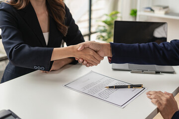 Job application concept: Manager and job applicant shake hands after a job interview. Job...
