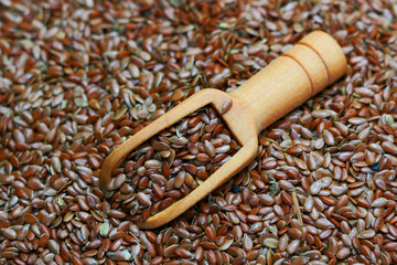 Flax seeds with a wooden scoop on a background Flex Seeds