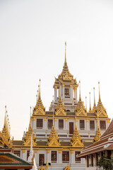 Fototapeta premium golden spires on top of buddhist temple in bangkok thailand