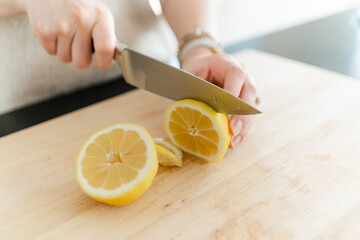 Slicing a Lemon on Wood Cutting Board
