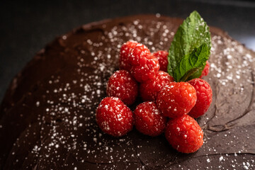 Close-Up of Raspberries and Mint On Chocolate Cake