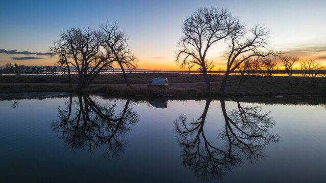 Sunrise Serenity: Van beside Calm Waters