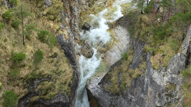 Alpine river and waterfall in Bavaria, Germany. Powerful water flow in slow-motion