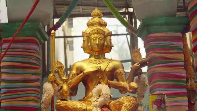 Phra Phrom (Brahma) - Four-Faced Buddha Golden Sculpture. closeup shot