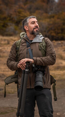 Fototapeta premium Male photographer with a camera in stunning nature