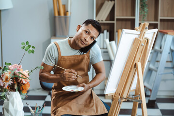 artist painting on canvas in the home studio, fine arts and creativity concept.
