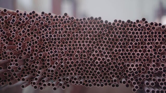 Stack of Copper tubes for heat exchangers. Lots of pipes to produce. Heating element. Factory production.