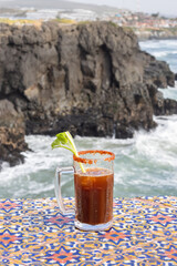 Bloody MaryBloody Mary style michelada in jar on bar with ocean view