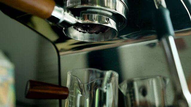 flowing of coffee water Using the Bottomless espresso coffee maker, making coffee at home.