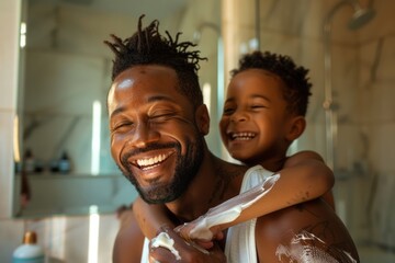 Black man is laughing and smiling preparing for the day in the bathroom with hydrating cream, a child is in the back, friendly parenthood concept