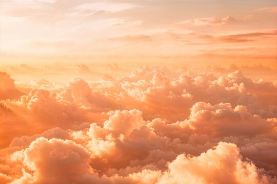 The sky, with a palette of peach and gold, as fluffy clouds catch the setting sun, creates a tranquil and heavenly atmosphere suitable for serene visual designs and inspirational content.
