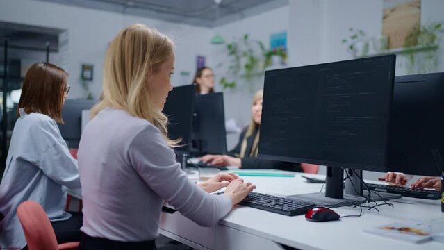 Female Office Workers Of Small IT Company, Women IT Professionals Sitting At Tables And Working