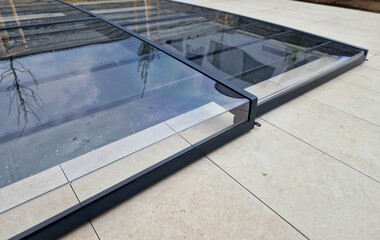 folding pool roof. the cover made of aluminum and plexiglass runs on rails. protects the pool from...